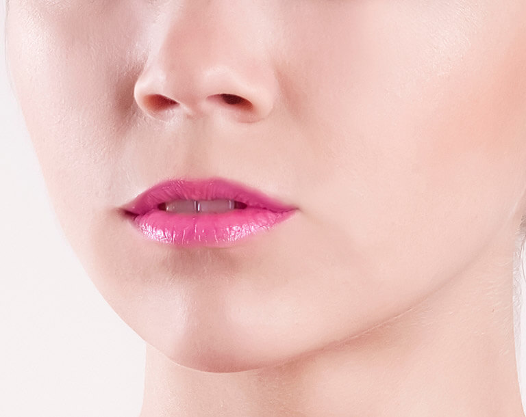 Close up of a woman's pink lips. They are fairly thin.